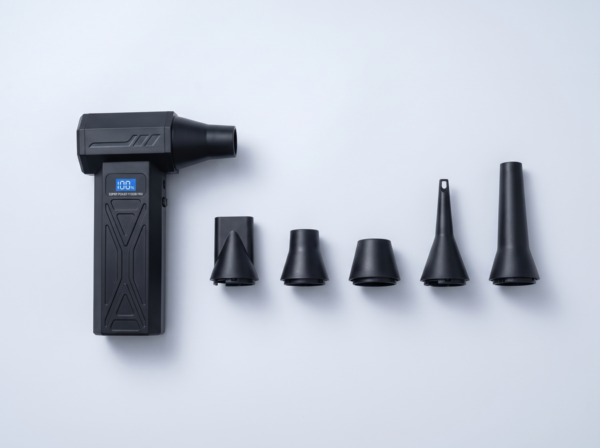 Handheld blower lying beside its nozzles, laid out in a row